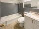 Clean bathroom featuring a tub with shower, toilet, and vanity sink with white cabinets at 1793 Witt Cir, Austell, GA 30168