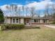 Charming single-story home with tan siding, red shutters, brick accents, and a well-maintained front yard at 1793 Witt Cir, Austell, GA 30168