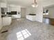 Bright kitchen featuring white cabinets, laminate countertops, and neutral colored tile flooring at 1793 Witt Cir, Austell, GA 30168