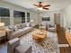 Bright living room with large windows, modern furniture, stylish rug, and ceiling fan at 1793 Witt Cir, Austell, GA 30168