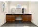 Bathroom featuring dual vanity with black countertops and oval mirrors at 529 Claude Scott Rd, Canton, GA 30115