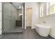 Bright bathroom featuring a glass shower, soaking tub, and tiled floors at 529 Claude Scott Rd, Canton, GA 30115