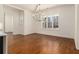 This dining room features a modern chandelier, hardwood floors, large windows overlooking a well landscaped yard at 529 Claude Scott Rd, Canton, GA 30115