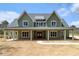 Charming two-story home with a covered porch, green siding, and a welcoming red front door at 529 Claude Scott Rd, Canton, GA 30115