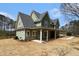Charming two-story home with a covered porch, green siding, and a large propane tank out back at 529 Claude Scott Rd, Canton, GA 30115