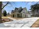 Charming home exterior with a spacious porch, large driveway, and well-maintained landscaping at 529 Claude Scott Rd, Canton, GA 30115