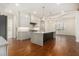 This open kitchen features a large marble island, custom cabinetry, and modern pendant lighting at 529 Claude Scott Rd, Canton, GA 30115