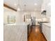 Spacious kitchen features marble counters, stainless appliances, custom cabinetry and a kitchen island with bar stool seating at 529 Claude Scott Rd, Canton, GA 30115