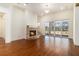 Cozy living room with hardwood floors, brick fireplace, and ample natural light from a glass sliding door at 529 Claude Scott Rd, Canton, GA 30115