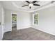 Large bedroom with ceiling fan, neutral carpet, and view into the bathroom at 221 Makayla Way, Temple, GA 30179