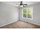Clean and simple bedroom with ceiling fan, neutral paint, and carpet at 221 Makayla Way, Temple, GA 30179