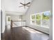 Spacious living room with vaulted ceiling, hardwood floors, abundant natural light, and an open staircase at 221 Makayla Way, Temple, GA 30179