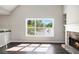 Bright living room showcasing hardwood floors, natural light, and a stone fireplace with built-in shelving at 221 Makayla Way, Temple, GA 30179