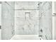 Elegant bathroom shower with white marble tiling and an inset shelf at 2657 Lenox Ne Rd # 29-1, Atlanta, GA 30324