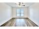 Bright bedroom with light-colored walls and floors, a ceiling fan, and a large window at 2657 Lenox Ne Rd # 29-1, Atlanta, GA 30324
