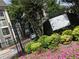Attractive community sign with colorful flowers in front of well-maintained condominium complex at 2657 Lenox Ne Rd # 29-1, Atlanta, GA 30324