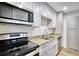Modern kitchen with white cabinets, granite countertops, stainless steel appliances and new floors at 2657 Lenox Ne Rd # 29-1, Atlanta, GA 30324
