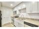 Modern kitchen with stainless steel appliances, granite countertops, white cabinetry and new floors at 2657 Lenox Ne Rd # 29-1, Atlanta, GA 30324