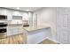 Well-lit kitchen features stainless steel appliances, granite countertops, white cabinetry, and hardwood flooring at 2657 Lenox Ne Rd # 29-1, Atlanta, GA 30324