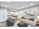 Comfortable living room adjacent to a kitchen with stainless steel appliances and barstool seating at 2657 Lenox Ne Rd # 29-1, Atlanta, GA 30324