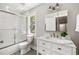 Modern bathroom with white subway tile shower and white vanity with stone countertops at 517 Daniel Ave, Decatur, GA 30032