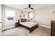 Neutral bedroom featuring a comfortable bed, carpeted floor, natural light and modern fixtures at 517 Daniel Ave, Decatur, GA 30032