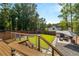 Backyard deck steps leading to a manicured lawn, patio set and storage outbuilding at 517 Daniel Ave, Decatur, GA 30032