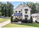 Charming two-story modern farmhouse with manicured front lawn, porch, and black window and door accents at 517 Daniel Ave, Decatur, GA 30032
