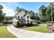 Attractive two-story farmhouse with a long driveway and well-manicured lawn and landscaping in a parklike setting at 517 Daniel Ave, Decatur, GA 30032