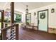 Inviting front porch with seating, stylish railing, wood flooring, brick accents, and eye-catching front door at 517 Daniel Ave, Decatur, GA 30032