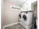 Functional laundry room equipped with a washer, dryer, and ample cabinet space at 517 Daniel Ave, Decatur, GA 30032