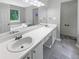 Bright bathroom with double sink vanity, large mirror, soaking tub, and tiled shower at 12 Bonnie Glen Ln, Hampton, GA 30228