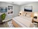 Comfortable bedroom features a neutral color scheme and a large window overlooking the backyard, virtually staged at 12 Bonnie Glen Ln, Hampton, GA 30228