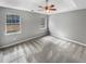 The bedroom has a ceiling fan, neutral walls, carpeting, and windows for natural light at 12 Bonnie Glen Ln, Hampton, GA 30228