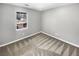 Simple bedroom features neutral carpeting and a window overlooking the backyard, creating a calming atmosphere at 12 Bonnie Glen Ln, Hampton, GA 30228