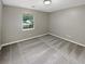 Carpeted bedroom with natural light from a window and neutral paint color at 12 Bonnie Glen Ln, Hampton, GA 30228