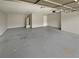 Spacious garage interior with concrete floor, utility closet, and white door at 12 Bonnie Glen Ln, Hampton, GA 30228