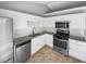 Modern kitchen features granite countertops and stainless steel appliances at 12 Bonnie Glen Ln, Hampton, GA 30228