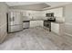Modern kitchen with stainless steel appliances, white cabinets, and tile flooring at 12 Bonnie Glen Ln, Hampton, GA 30228