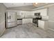 Modern kitchen with stainless steel appliances, light countertops, and plenty of cabinet space for storage at 12 Bonnie Glen Ln, Hampton, GA 30228