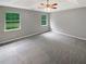 Light-filled main bedroom with two windows and neutral carpeting at 12 Bonnie Glen Ln, Hampton, GA 30228