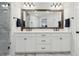 Double sink bathroom vanity with large mirror, modern lighting, and a glass-enclosed shower at 871 Dunning St, Marietta, GA 30060