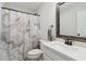 Bathroom featuring a white vanity, toilet, and shower with a decorative marble-patterned curtain at 871 Dunning St, Marietta, GA 30060