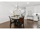 Dining area with hardwood floors, a chandelier, and a modern bar style countertop at 871 Dunning St, Marietta, GA 30060