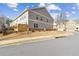 Exterior side view of townhome with gray siding, small backyard, and street view at 871 Dunning St, Marietta, GA 30060
