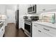 Bright kitchen with stainless steel appliances, white cabinetry, marble countertops and subway tile backsplash at 871 Dunning St, Marietta, GA 30060