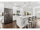 Bright kitchen featuring stainless steel appliances, marble countertops, and barstool seating with elegant pendant lighting at 871 Dunning St, Marietta, GA 30060