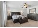 A spacious main bedroom suite with a ceiling fan, dresser, and sitting area with a decorative ottoman at 871 Dunning St, Marietta, GA 30060