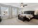 Spacious main bedroom with three windows, a ceiling fan, and a tufted headboard at 871 Dunning St, Marietta, GA 30060