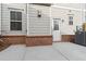 A patio featuring brick accents, a white door, and an AC unit at 871 Dunning St, Marietta, GA 30060